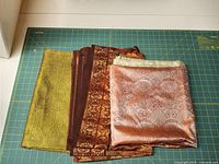 Stack of three silk fabric lengths folded