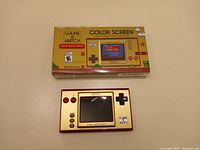 Front view of sealed box and opened handheld