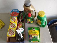 Overview of fertilizers, seed kits, packets and nozzle on table