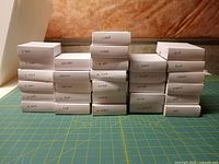 Stacked labelled white boxes of globe safety pins