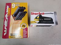 Front view of boxed Wiltshire Laser knife block set and boxed Starfrit french fry cutter
