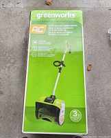 Front of sealed box showing product image and specs