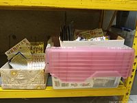 Three boxes of sticker sheets on shelf