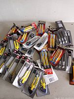 Pile of packaged utility and craft knives