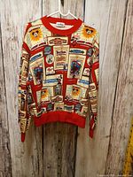 Front view of sweatshirt on hanger showing all-over print and red trim
