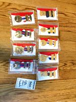 Ten packaged medals arranged on wood floor