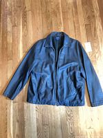 Front view of black leather jacket showing collar, zipper and pockets