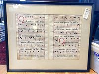 Front view of framed chant folio showing two-page layout, mat, and frame