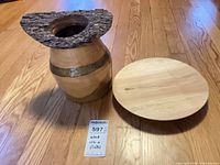 Urn and platter on floor with lot tag visible