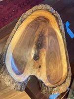 Top view of walnut live-edge bowl showing interior grain and bark edge