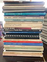 Stacked view of all songbooks showing spines and variety of titles