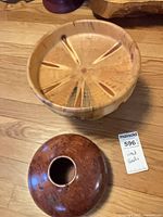 Top view of both wooden pieces showing interior of light compote and exterior of dark burl bowl