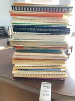 Stack of spiral-bound and softcover music books