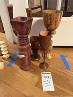 All five hand-turned wooden goblets standing on floor