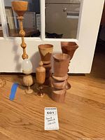 Group of seven hand-turned wooden pieces standing together