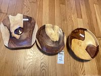 all three wooden serving pieces on hardwood floor
