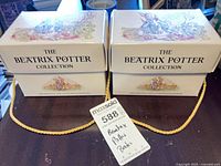 Two illustrated slipcases with lids closed, showing external condition