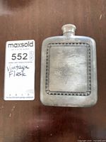 Front of pewter flask with engraving and screw cap