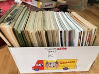 Box containing approximately 40–60 organ sheet music booklets