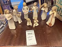 All eight figurines grouped on tabletop