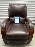 Front view of brown recliner showing seat, backrest and wood-accented arms