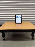 Overall view of square coffee table with tablet for scale