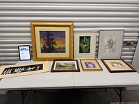 Group shot of all seven artworks displayed on table