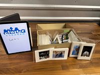 Box with envelopes and greeting cards, tablet showing lot marker
