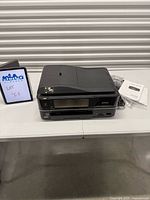 Front angled view of Epson Artisan 810 printer with accessories and manuals
