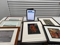 All six framed artworks laid out on table