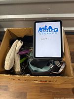 Full box view with assorted kitchen items and tablet