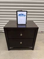 Front view of nightstand showing two drawers, metal knobs, espresso finish