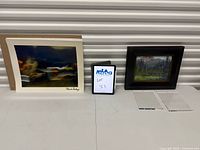 Group image of photograph print, framed painting, acrylic plates