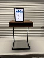 Front view of wood top side table on black metal C frame