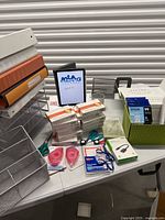 Overall view showing mesh organizers, Strathmore card packs, scissors, adhesive rollers, badge holders, Belkin adapter and Epson ink