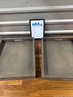 Both oversized gray-washed wooden trays side by side