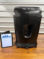 Full view of Staples SPL-TXC16HSA shredder on casters next to scale reference tablet