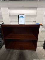 Front view of cherry finish bookcase showing two shelves