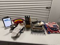 Full lot view showing knife block, mixing bowls, cookware, bakeware, linens, foil and partyware