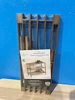 Front of packaged Mainstays 3-Tier Wood Shoe Rack showing parts and label