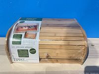 New shrink-wrapped bamboo roll-top bread box with label visible