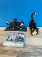 Bookend pair, letter holder and sealed napkins on tabletop