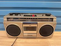 Front view showing speakers, cassette deck, tuner scale, brand logo