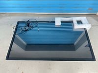 Front view of large Elo touchscreen monitor with cables and foam supports