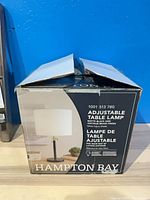 Retail box showing Hampton Bay adjustable table lamp details