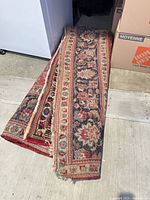 Folded large Persian-style rug showing overall design and size