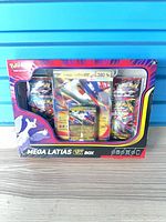Front view of sealed Mega Latias EX Box showing booster packs, promo cards