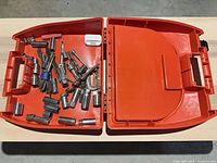 Open case showing assorted sockets, adapters and holders