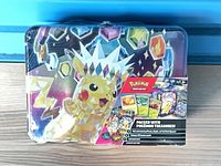 Front view of sealed Pokémon TCG treasure chest tin showing Pikachu artwork and contents label