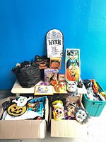 Overall lot showing all Halloween items on tables and in boxes